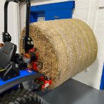 New Bale Spike for Compact Tractor shown on the back of a Solis Compact Tractor with bale attached