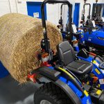 New Bale Spike for Compact Tractor shown on the back of a Solis Compact Tractor with bale attached