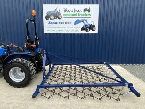 8ft Chain Harrow on a Solis Compact Tractor