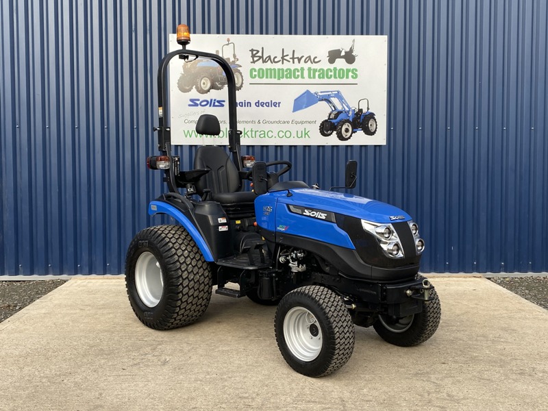 Blue Solis compact tractor side view outside Blacktrac.