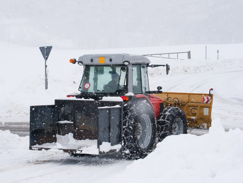 compact tractor with snow plough attachment ploughing the heavy snow in the uk