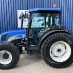 Side view of blue New Holland T4030 Tractor