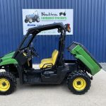 Side view of John Deere XUV Gator with back tipped