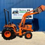 Side view of Kubota B8200 4WD Compact Tractor with Front Loader with loader lifted