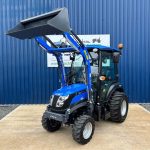 Front view of Solis 26HST Compact Tractor with Cab, Loader & Bucket with loader raised