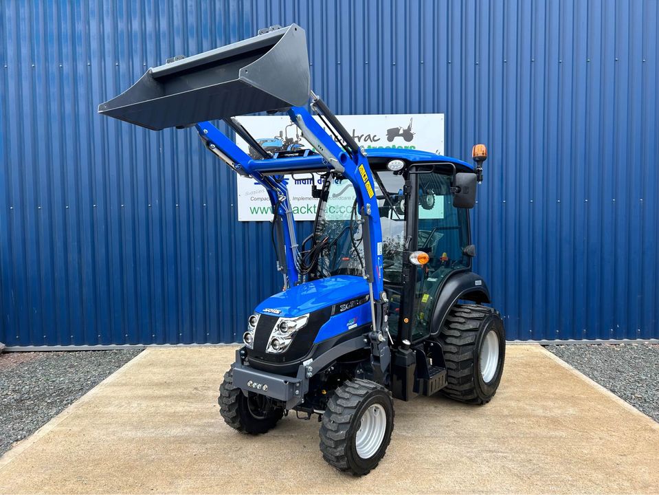 Front view of Solis 26HST Compact Tractor with Cab, Loader & Bucket with loader raised