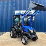 Front view of Solis 26HST Compact Tractor with Cab, Loader & Bucket with loader raised