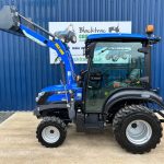 Side view of Solis 26HST Compact Tractor with Cab, Loader & Bucket with loader raised