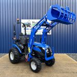 Front view of Solis 26HST Compact Tractor with Loader and Hydraulic Grab Bucket with loader raised