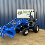 Front view of Solis 26HST Compact Tractor with Loader and Hydraulic Grab Bucket with bucket open