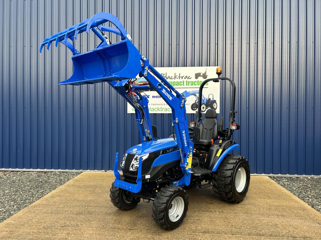 Front view of Solis 26HST Compact Tractor with Loader and Hydraulic Grab Bucket