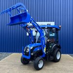 Front view of new Solis 26HST (Hydrostatic) Compact Tractor with Cab, Loader & Grab Bucket with loader raised and bucket open