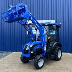 Front view of new Solis 26HST (Hydrostatic) Compact Tractor with Cab, Loader & Grab Bucket with loader raised
