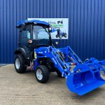 Front view of new Solis 26HST (Hydrostatic) Compact Tractor with Cab, Loader & Grab Bucket with loader lowered