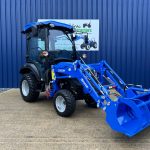 Front view of new Solis 26HST (Hydrostatic) Compact Tractor with Cab, Loader & Grab Bucket with loader lowered