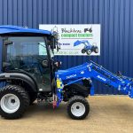 Side view of new Solis 26HST (Hydrostatic) Compact Tractor with Cab, Loader & 4:1 Bucket with loader lowered