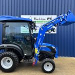 Side view of new Solis 26HST (Hydrostatic) Compact Tractor with Cab, Loader & 4:1 Bucket with loader raised