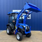 Front view of new Solis 26HST (Hydrostatic) Compact Tractor with Cab, Loader & 4:1 Bucket with loader raised