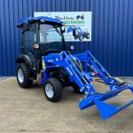 Front view of new Solis 26HST (Hydrostatic) Compact Tractor with Cab, Loader & 4:1 Bucket with loader lowered and bucket open