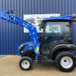 Side view of new Solis 26HST (Hydrostatic) Compact Tractor with Cab, Loader & 4:1 Bucket with loader raised and bucket opened