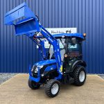 Front view of new Solis 26HST (Hydrostatic) Compact Tractor with Cab, Loader & 4:1 Bucket with loader raised and bucket open