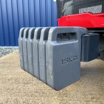 Close up of front weights on the Massey Ferguson 1740M 4WD Compact Tractor